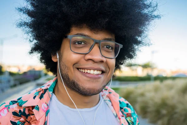 Portrait of young latin man outdoors.