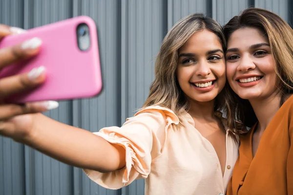 Dois amigos tomando selfie com telefone ao ar livre. — Fotografia de Stock