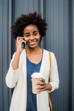 İş kadını dışarıda telefonla konuşuyor..