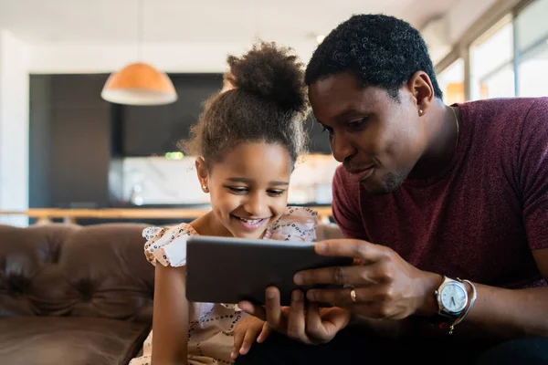 Ojciec i córka korzystający z tabletu cyfrowego w domu. — Zdjęcie stockowe
