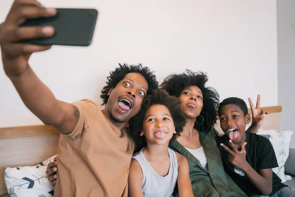 Familjen tar selfie tillsammans med telefon hemma. — Stockfoto