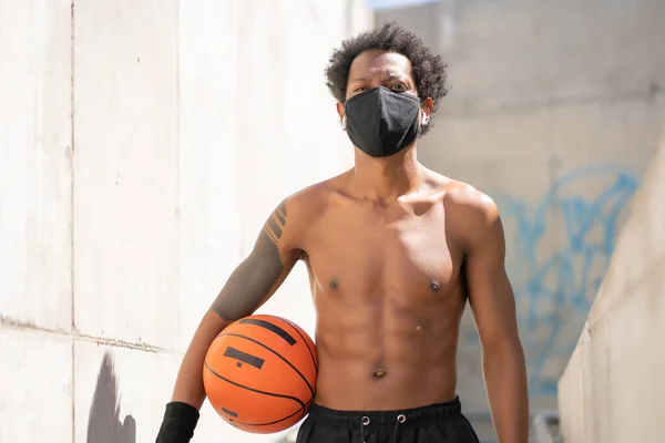 Afro sportowiec trzyma piłkę do koszykówki. — Zdjęcie stockowe