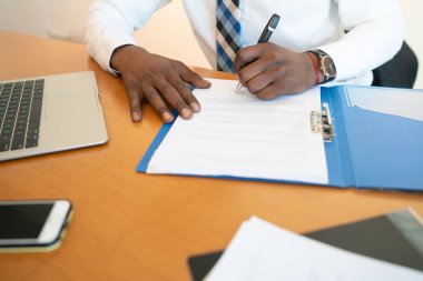 Ofiste evraklarla çalışan bir işadamı..