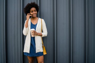 İş kadını dışarıda telefonla konuşuyor..