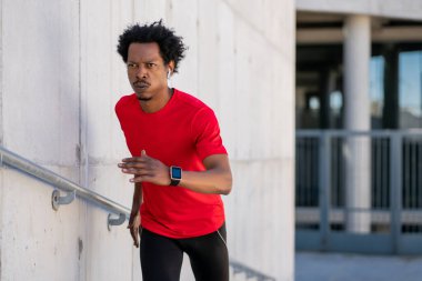 Atletik adam koşuyor ve dışarıda egzersiz yapıyor..