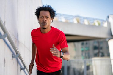 Afro atletik adam dışarıda egzersiz yapıyor..