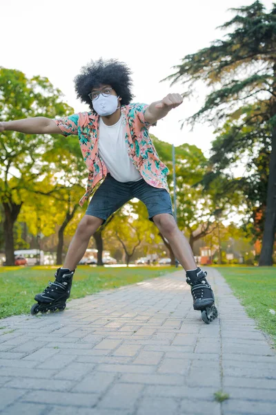 Latin man roller skating outdoors.