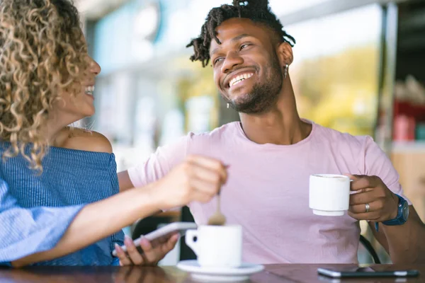 Young couple drinking coffee at a coffee shop.