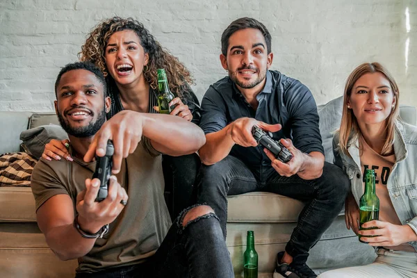 Group of friends playing video games together. Royalty Free Stock Photos