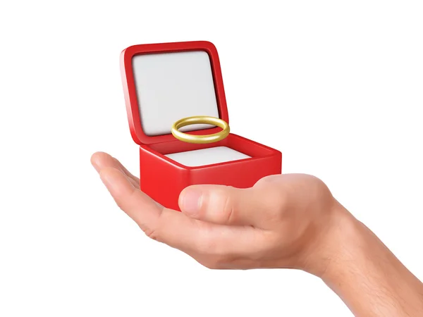 Mão segurar uma caixa de presente com anel de casamento — Fotografia de Stock