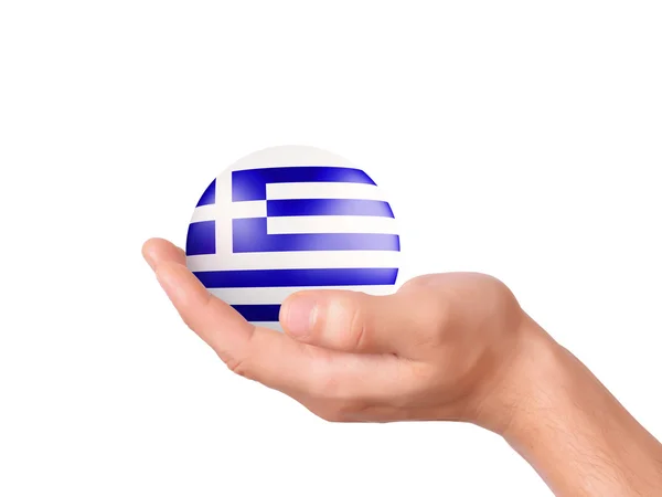 Mão segurar ícone bandeira da Grécia no terreno de panificação branco — Fotografia de Stock