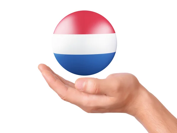Рука утримати Нідерланди значок прапорця білий bakground — стокове фото