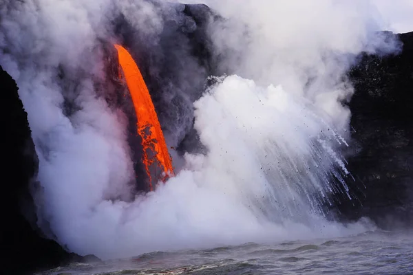 Lava flowing into ocean from the cliff on Big island Hawaii