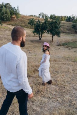 Kırsaldaki güzel çift, beyaz elbiseli yakışıklı sakallı adam ve kadın. 