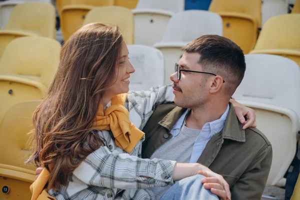 Young Couple Sitting Stands Football Stadium Girl Sitting Laps Her — Stock Photo, Image
