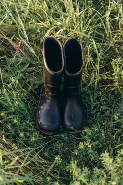 The black boots standing on the grass