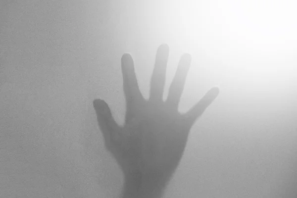 抽象的黑色和白色影子双手放在玻璃上 — 图库照片