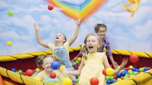 Children throw the balls in ball pool — Stock Video