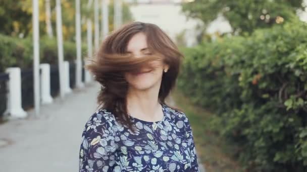 Happy young woman shaking her beautiful hair — Stock Video