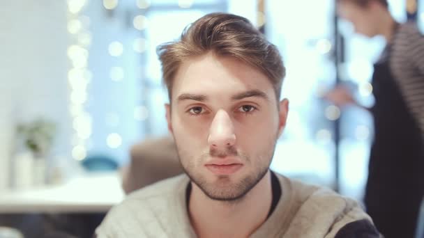 Jeune homme regardant la caméra dans le café — Video