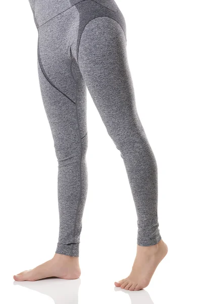 Close up view of woman legs from front side in gray sports thermo-underwear with pattern. — Stok Foto