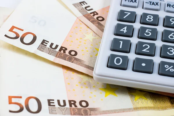 Fifty euro bills and a calculator — Stock Photo, Image