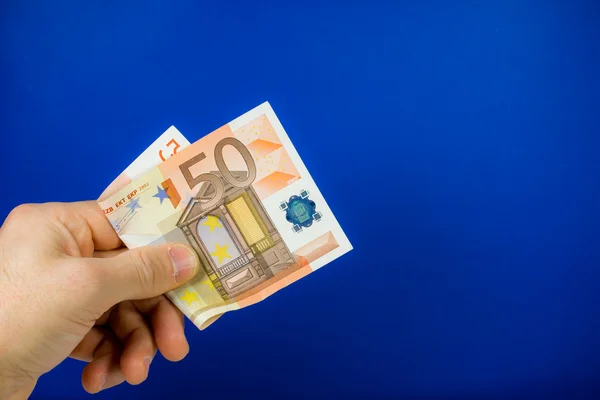 Hand holding out a banknote — Stock Photo, Image