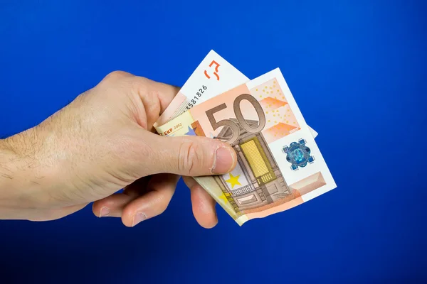 Hand holding out a banknote — Stock Photo, Image
