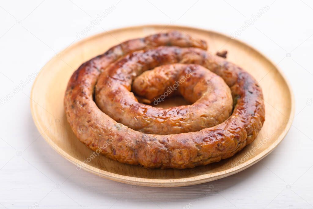 Northern Thai sausage (Sai Aua), Grilled intestine stuffed with minced pork, spices and herbs on white background, popular food in Chiangmai, Thailand