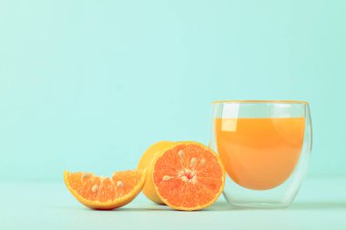 Taze mandalina portakal suyu ve arka planda cam suyu.