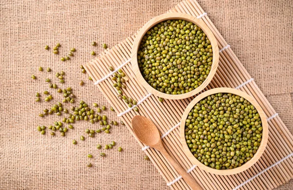 Mung bean seeds in a bowl with spoon, Food ingredients in Asian cuisine and produce mung bean sprout