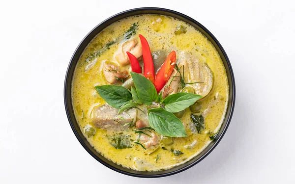 Top view of Thai green curry chicken in bowl on white background