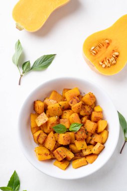 Roasted butternut squash pumpkin in a bowl on white background, Autumn homemade food