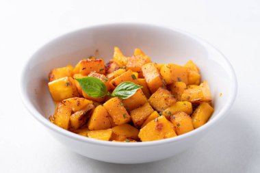 Roasted butternut squash pumpkin in a bowl on white background, Autumn homemade food
