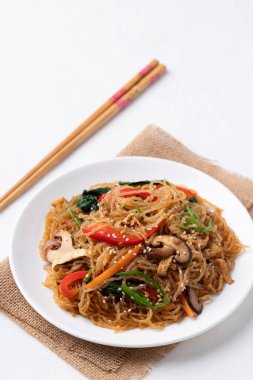 Japchae, Korean stir fried glass noodles with vegetables, pork, soy sauce and sesame oil