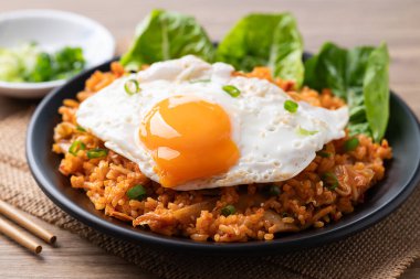 Korean kimchi fried rice with fried egg and spring onion on top