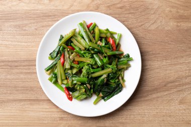 Beyaz tabakta soya soslu Çin lahanası ve ahşap arka plan, Tayland yemeği tarzı.