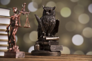 Golden scales of justice, books, Statue of Lady Justice. Owl and paragraph
