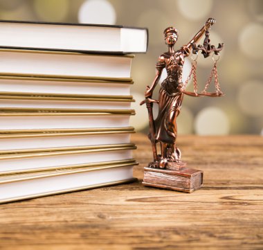 Golden scales of justice, books, Statue of Lady Justice. Owl and paragraph