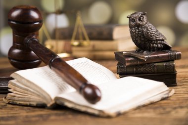 Golden scales of justice, books, Statue of Lady Justice. Owl and paragraph