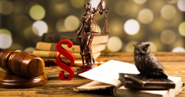 Golden scales of justice, books, Statue of Lady Justice. Owl and paragraph