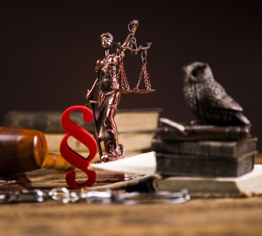 Golden scales of justice, books, Statue of Lady Justice. Owl and paragraph