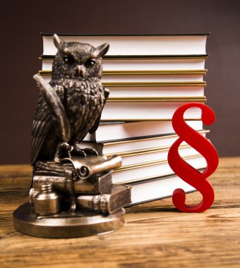 Golden scales of justice, books, Statue of Lady Justice. Owl and paragraph