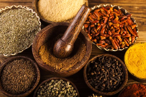 Spices and herbs in wooden bowls — Stock Photo, Image