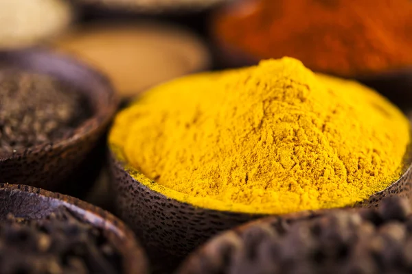 Spices and herbs in wooden bowls — Stock Photo, Image