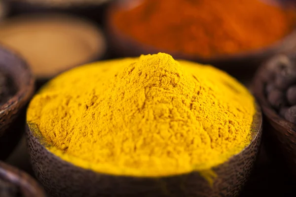 Spices and herbs in wooden bowls — Stock Photo, Image