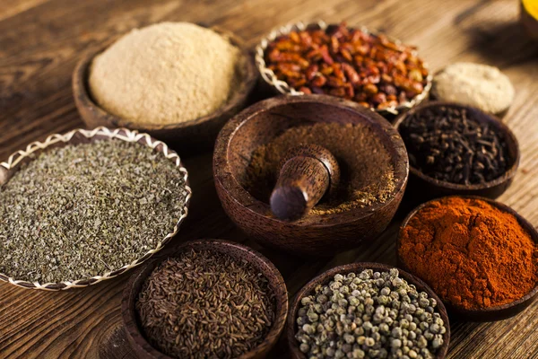 Spices and herbs in wooden bowls — Stock Photo, Image