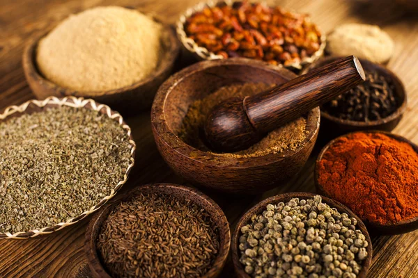 Spices and herbs in wooden bowls — Stock Photo, Image