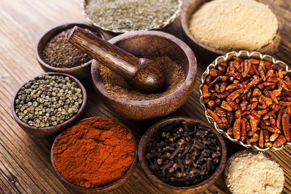 Spices and herbs in wooden bowls — Stock Photo, Image