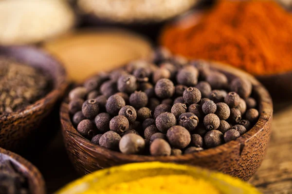 Spices and herbs in wooden bowls — Stock Photo, Image